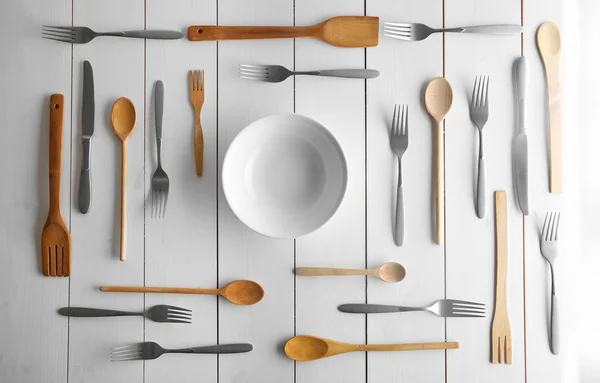 Plate and cutlery on white table — Stock Photo, Image