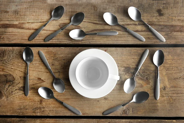 Ceramic cup and silver spoons — Stock Photo, Image