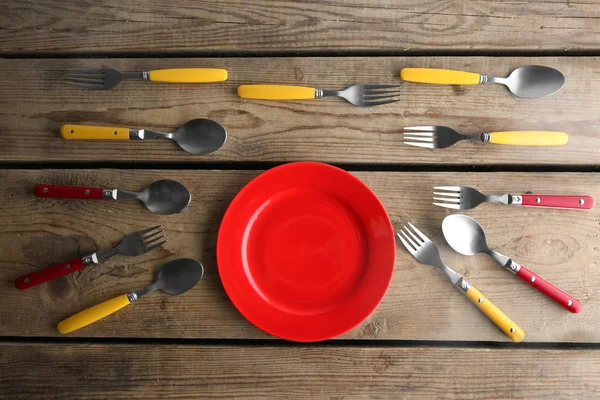 Plate and colorful flatware — Stock Photo, Image