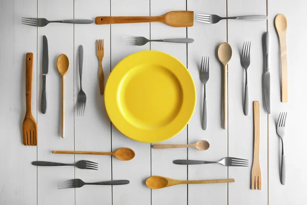 Plate and cutlery on white table — Stock Photo, Image