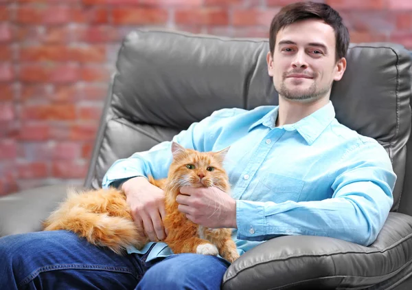 man with fluffy cat