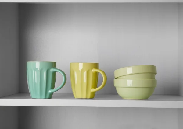 Dishes in cupboard in kitchen — Stock Photo, Image