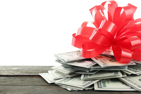 Pile of dollars with bow as gift — Stock Photo, Image