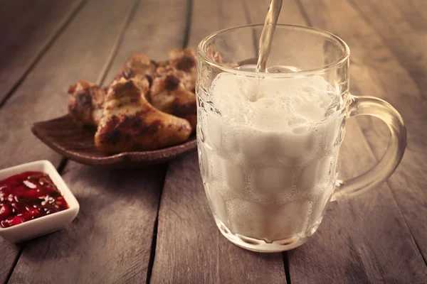 Glass of beer and chicken wings