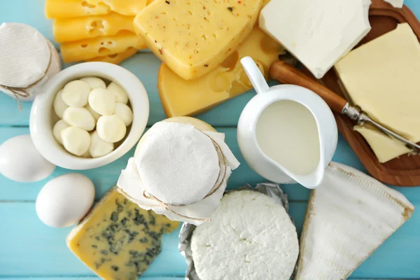 Set of fresh dairy products on blue wooden table, close up — Stock Photo, Image