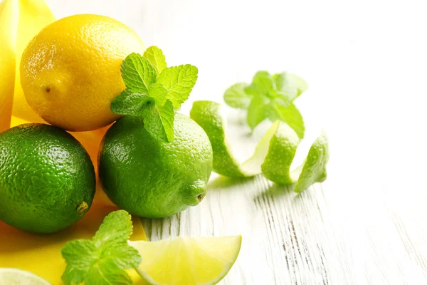 Fresh limes on yellow napkin — Stock Photo, Image