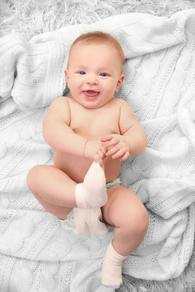 Adorable baby in diaper with blanket — Stock Photo, Image