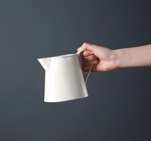 Hand holding white plastic jug — Stock Photo, Image