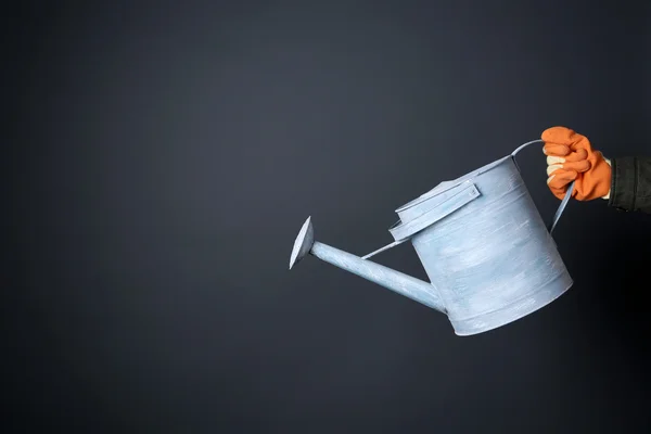 Hand holding metal watering can — Stock Photo, Image