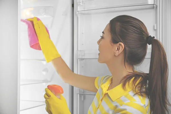 Woman washing refrigerator — Stock Photo, Image