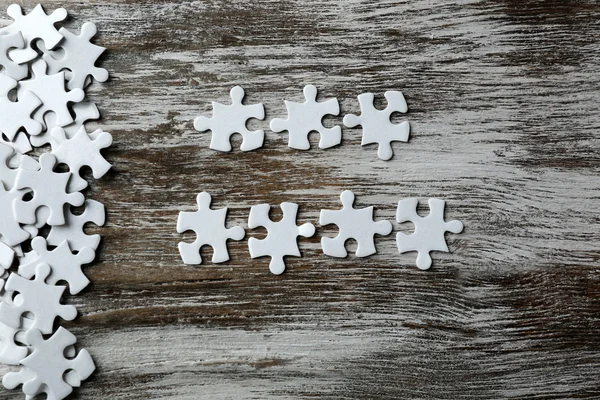 Incomplete puzzles on  table — Stock Photo, Image