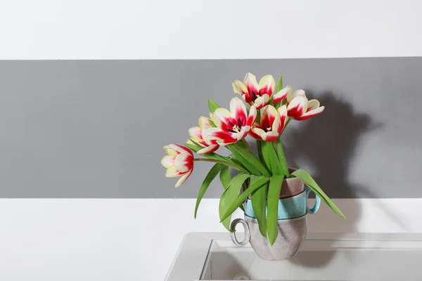 Bouquet of variegated tulips near striped wall — Stock Photo, Image