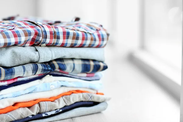 Male clothes lying on windowsill, closeup — Stock Photo, Image