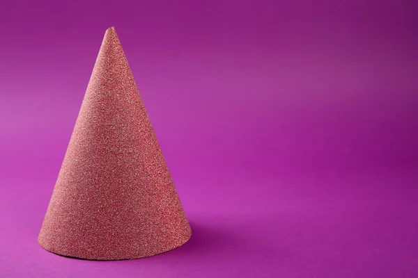 Pink Birthday hat on purple background — Stock Photo, Image