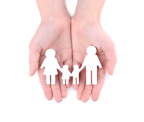 Female hands holding family figure on white background — Stock Photo, Image