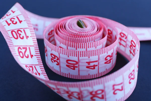 Pink measuring tape on a black background Stock Photo