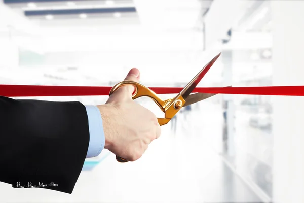 Businessman cutting red ribbon — Stock Photo, Image