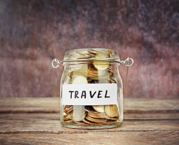 Jar for savings full of coins on wood background — Stock Photo, Image