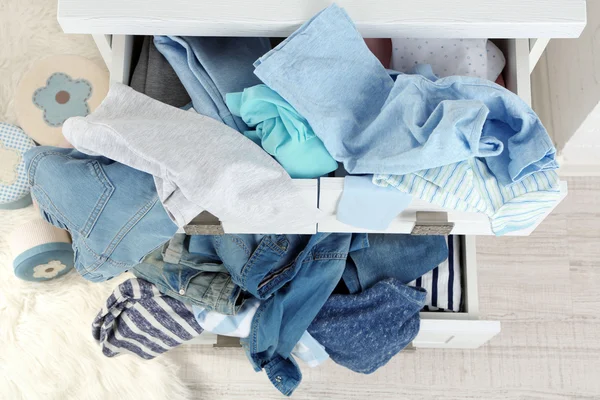 Clothes in wooden chest of drawer — Stock Photo, Image