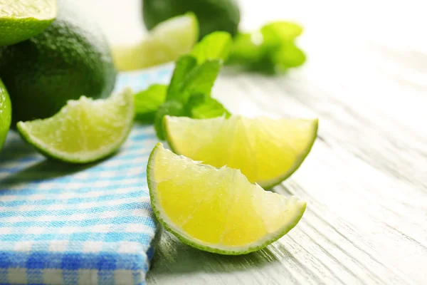 Fresh limes on napkin — Stock Photo, Image