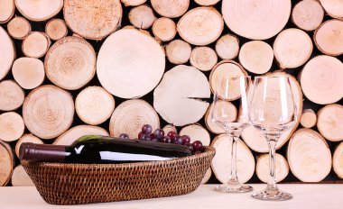 Bottle of red wine in basket 