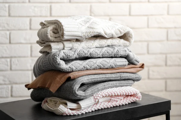 Stack of woolen clothes Stock Photo by ©belchonock 140263868