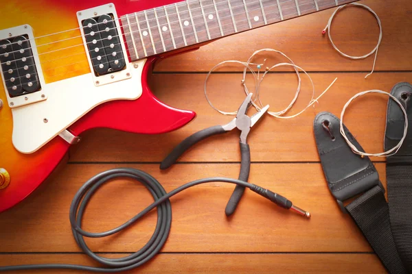 Electric guitar with pliers — Stock Photo, Image