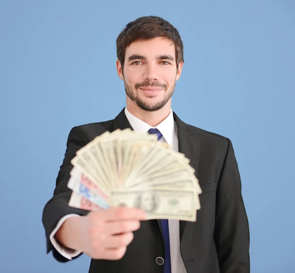 Man holding fan of banknotes — Stock Photo, Image