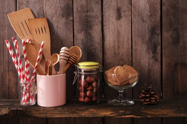 Utensil in pot with cookies and hazelnuts — Stock Photo, Image