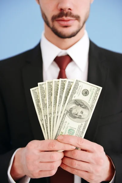 Man in a suit holding dollar banknotes — Stock Photo, Image