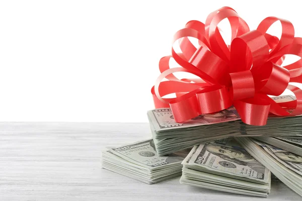 Mucchio di dollari con fiocco come regalo — Foto Stock