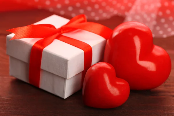 Gift box and decorative hearts — Stock Photo, Image