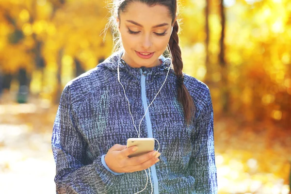 Young beautiful woman holding phone