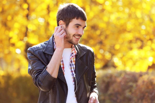 Man listening to music in a park — Stock Photo, Image