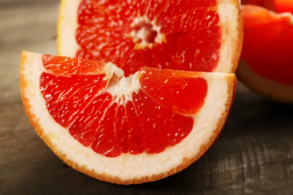 Sliced grapefruits on wooden background — Stock Photo, Image