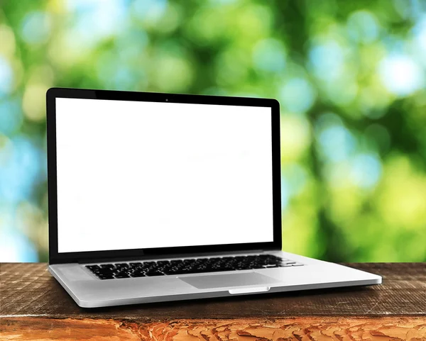 Laptop over wooden table — Stock Photo, Image