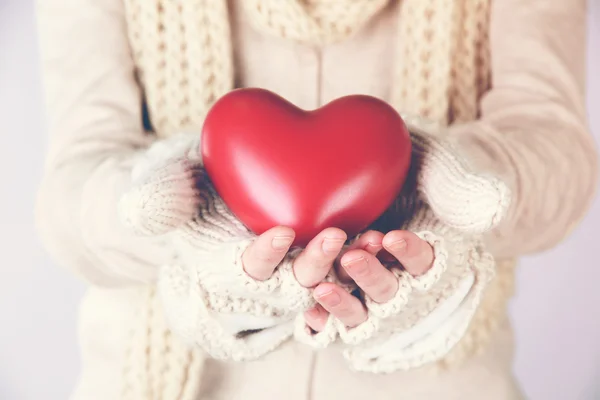 Weibliche Hände mit rotem Herz — Stockfoto