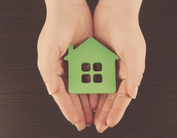 Mani femminili con modello di casa — Foto Stock