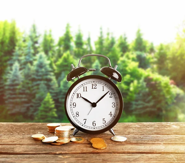 Alarm clock and money coins — Stock Photo, Image