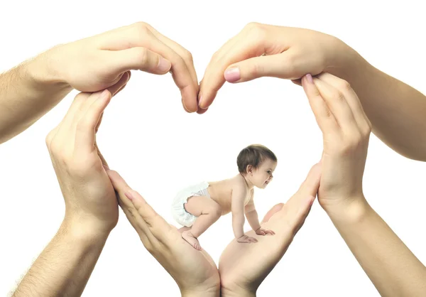 Baby girl crawling in heart-shaped hands — Stock Photo, Image