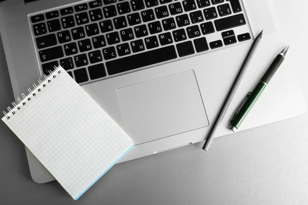 Notebook on laptop keyboard — Stock Photo, Image