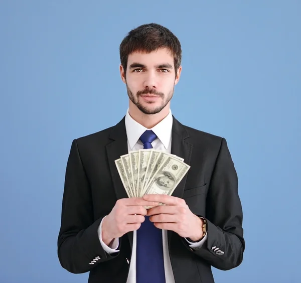 Man in a suit holding dollar banknotes — Stock Photo, Image