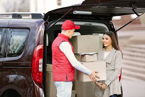 Delivery man holding package Stock Picture