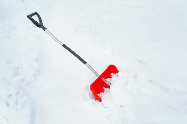 Winter concept. Red shovel — Stock Photo, Image