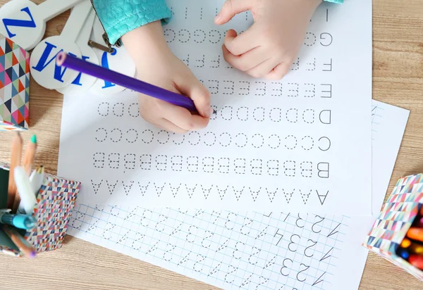 Little girl learning to write English — Stock Photo, Image