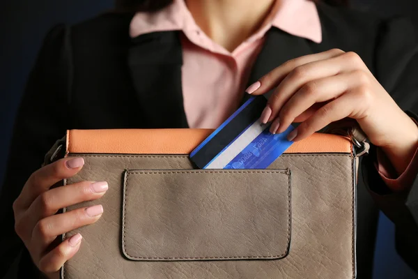 Businesswoman putting card in purse — Stock Photo, Image