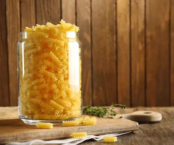 Raw pasta in glass jar — Stock Photo, Image