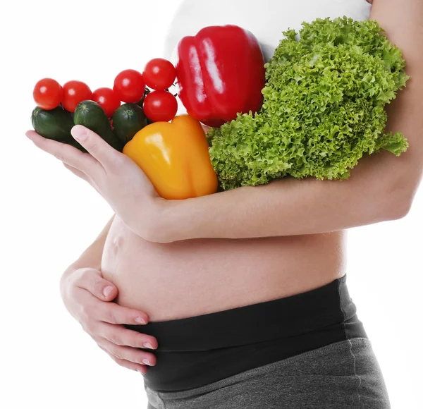 Gravid kvinna som håller grönsaker — Stockfoto