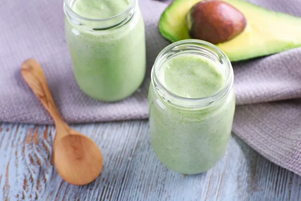 Avocado smoothie on wooden table — Stock Photo, Image