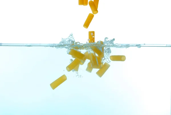 Falling pasta in water — Stock Photo, Image